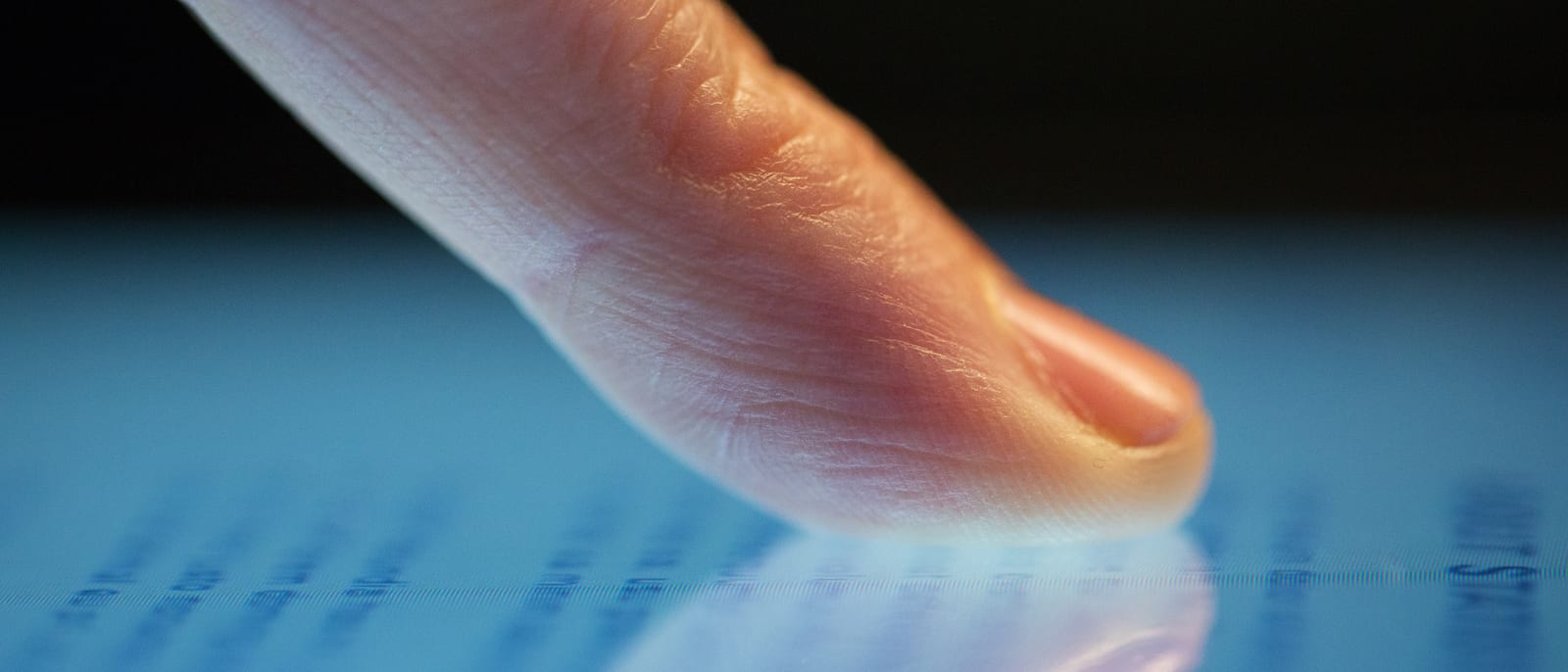 Close-up of a smartphone touchscreen being unlocked with a fingertip