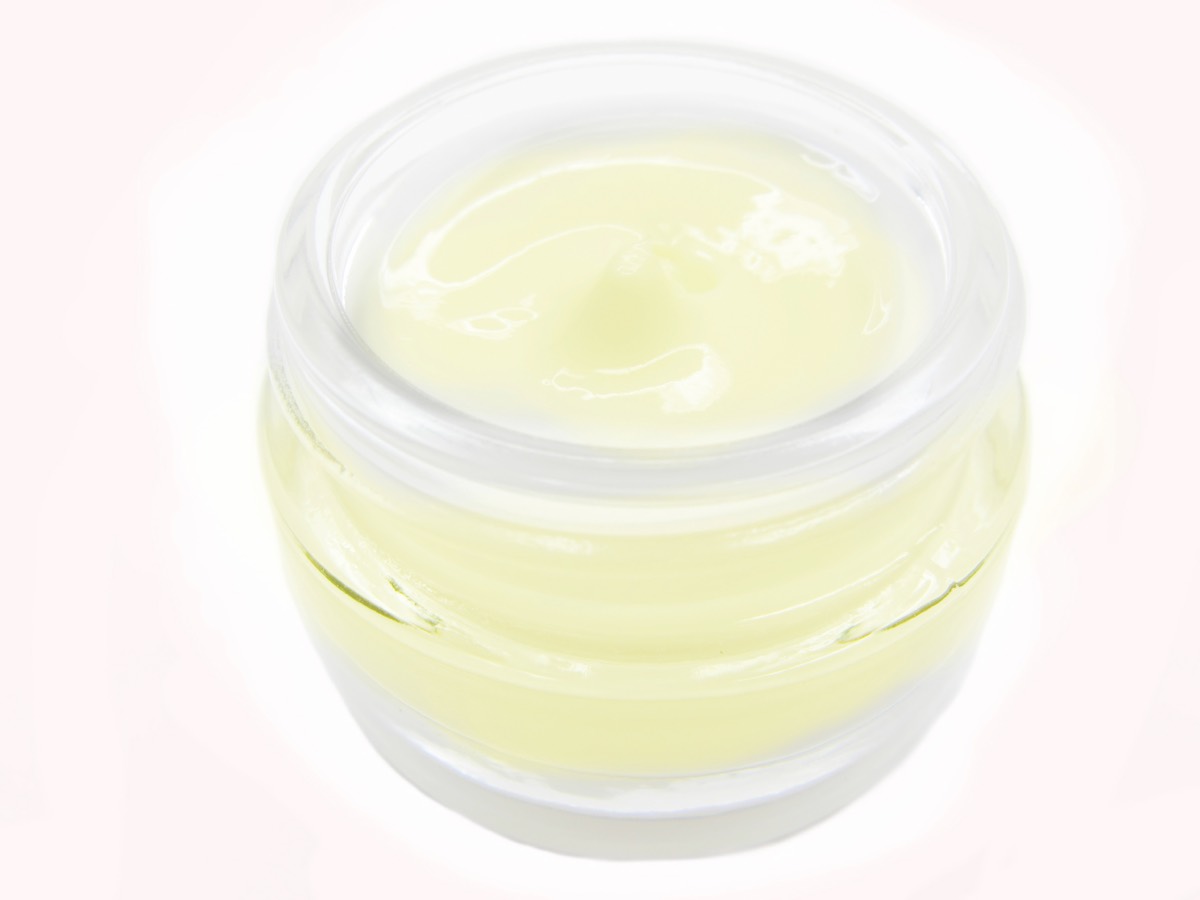 Assorted eye cream jars and cosmetic boxes displayed on a beauty store counter