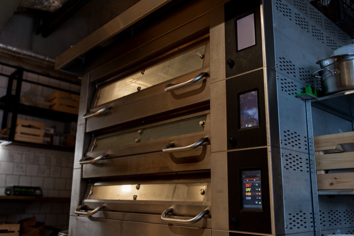 Dough entering a hot industrial oven on a conveyor in a food factory