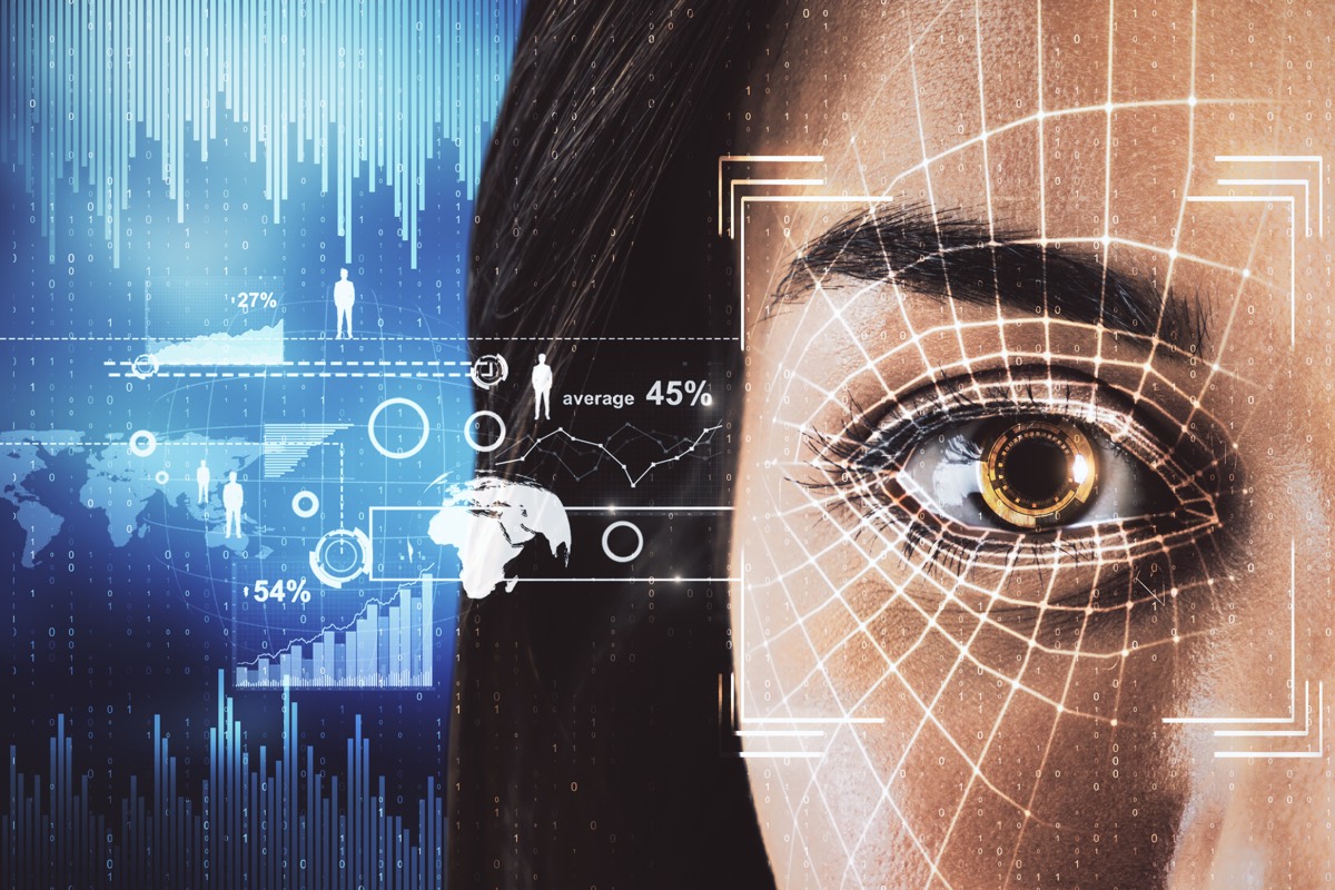 A grid of blurred human faces on a screen suggesting facial recognition