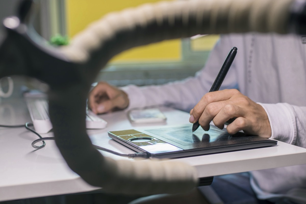 A digital artist's tablet displaying generative artwork in a studio