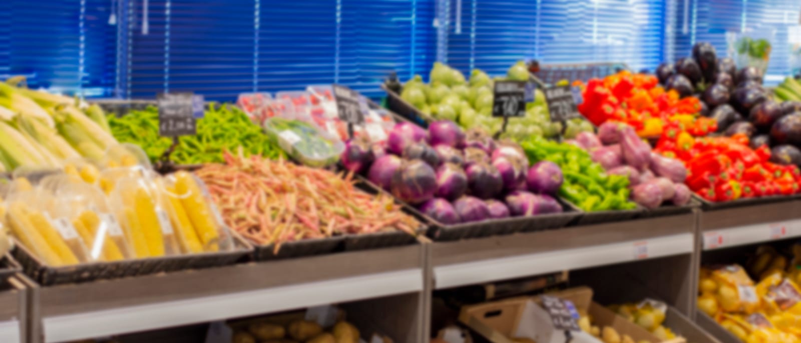 Rows of fresh produce and sprouts on display in a bright grocery market