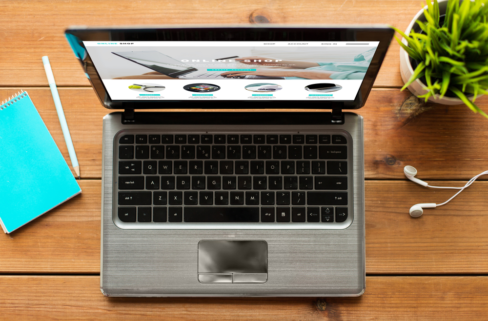 A web browser showing a merchant web page with hyperlinks on a laptop screen