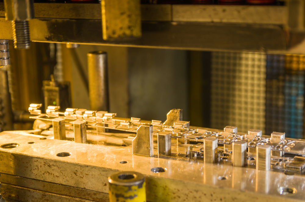 An industrial rubber molding press clamping a heated mold in a manufacturing plant