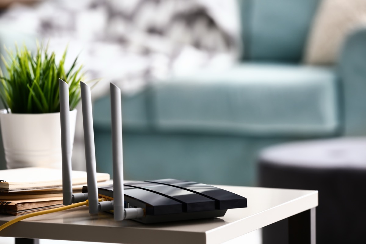 A Wi-Fi router with status lights on a desk