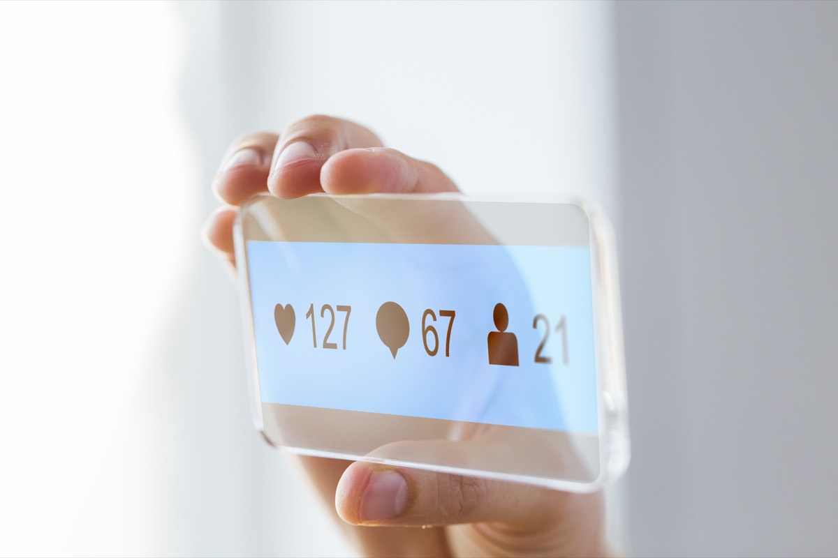 A smartphone screen showing a social media feed with a thumbs-up like button