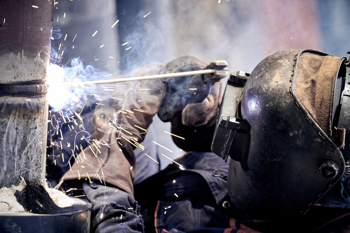 An industrial arc welding operation throwing sparks