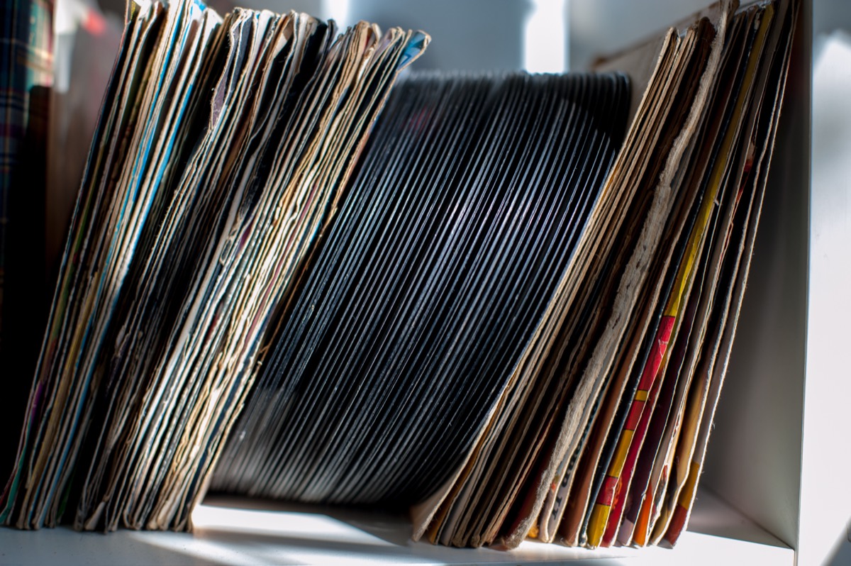 Shelves of archived master tapes and vinyl records in a recording studio vault