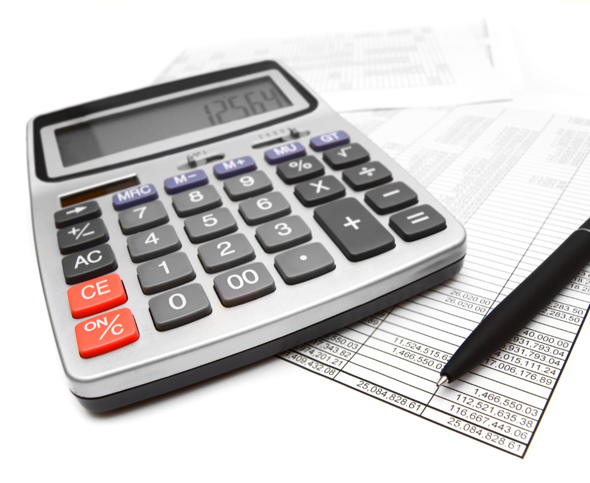 A founder budgeting IP costs with a calculator and documents