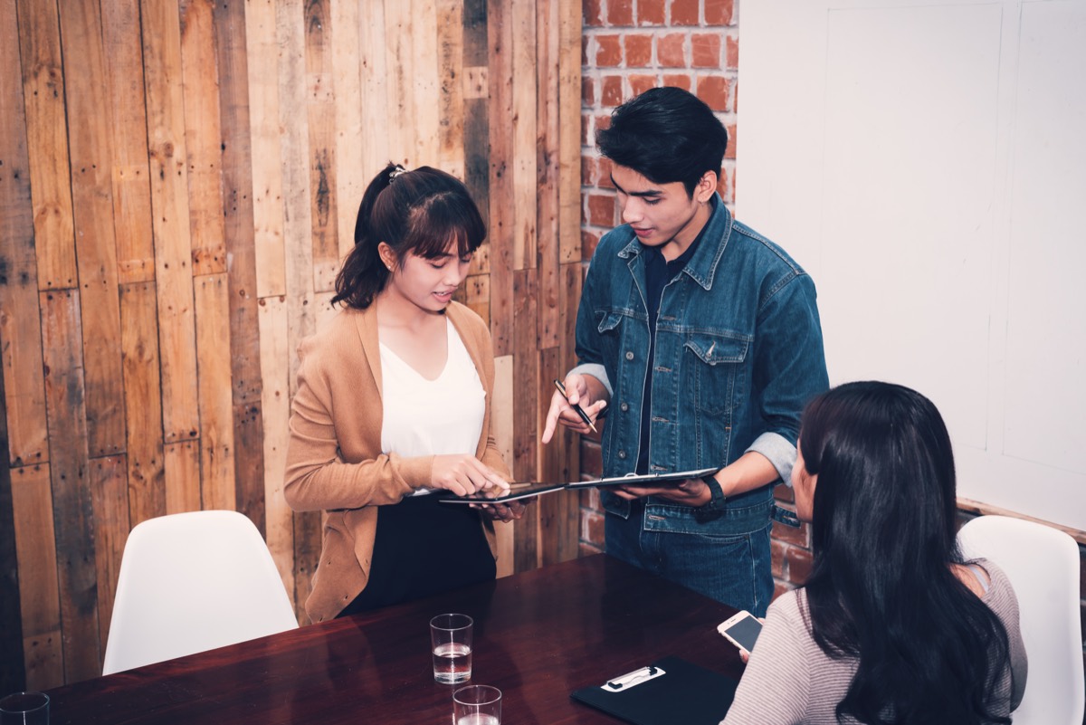 A startup team meeting with acquirer representatives in a modern office