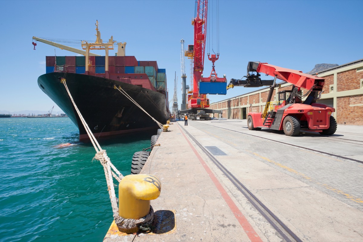 Container ship stacked with shipping containers arriving at a U.S. port