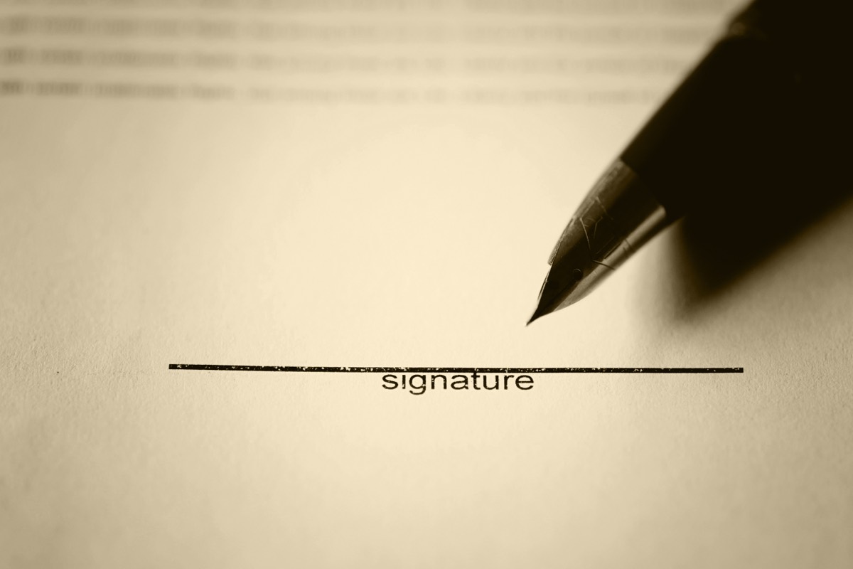 An employment contract with a non-compete clause on a desk with a pen