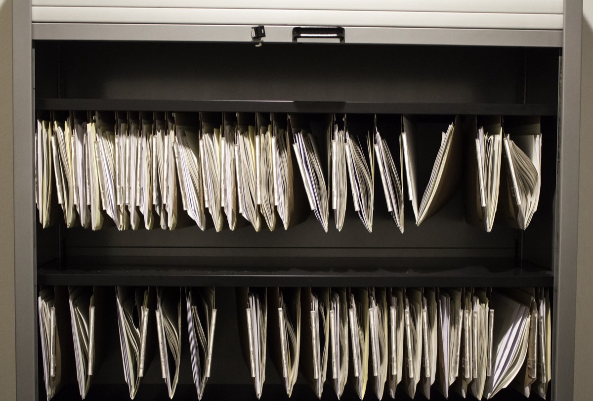 A locked filing cabinet holding confidential business documents in an office
