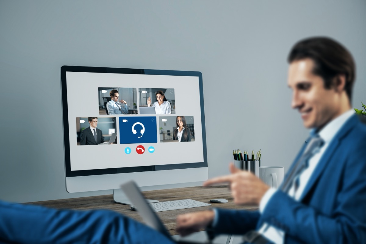 A manufacturing manager reviewing designs with an overseas supplier on a video call