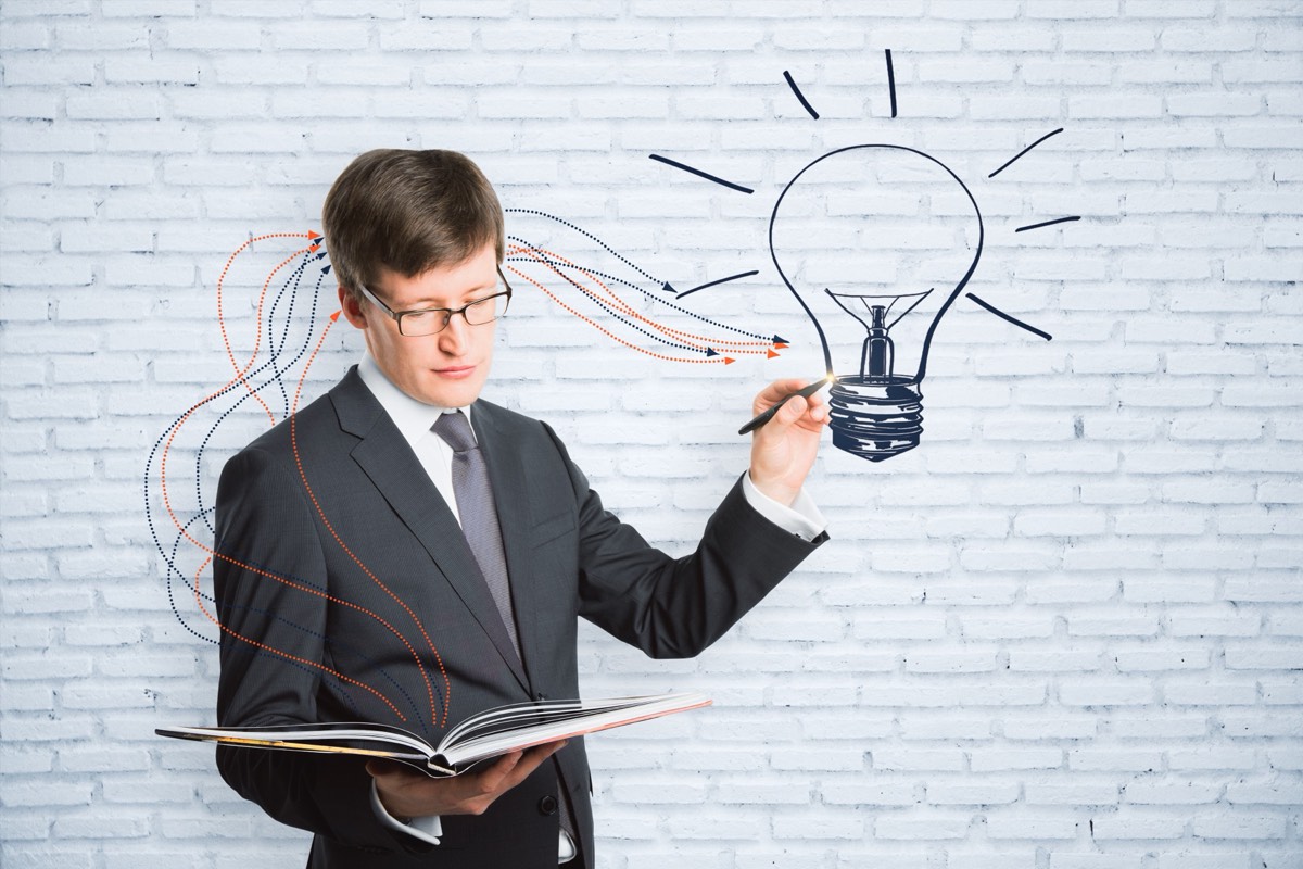Inventor reviewing patent application documents at a laptop