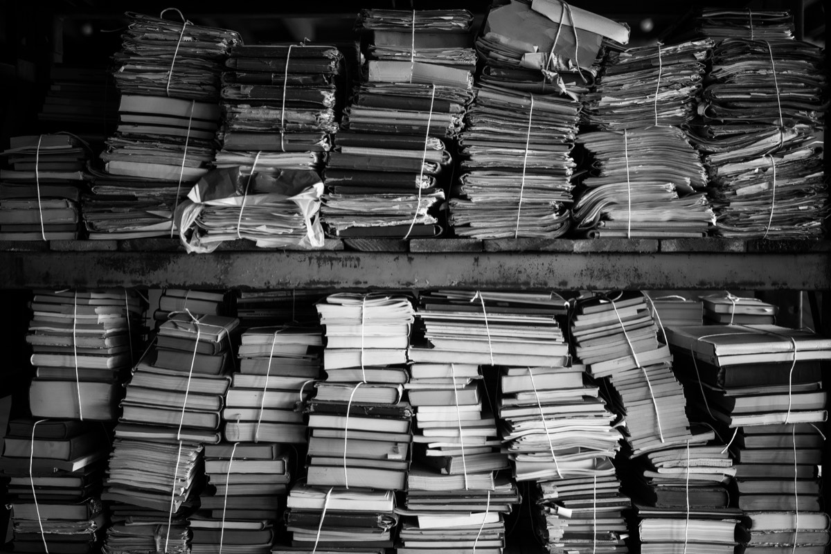 Shelves of old books and archived creative works in a library