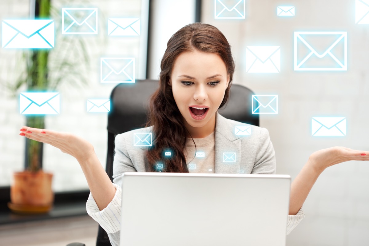 Person at a desk reading a formal dispute notification email about their domain name
