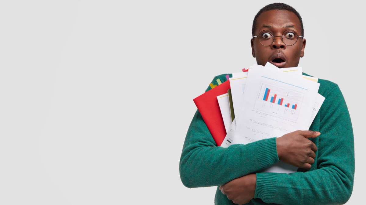 Worried small business owner reading a formal legal letter at a shop counter