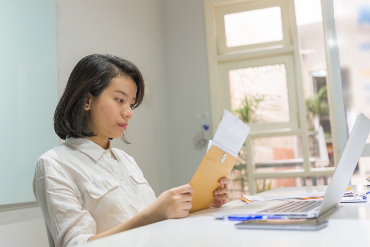 Person reading an official USPTO letter at a desk