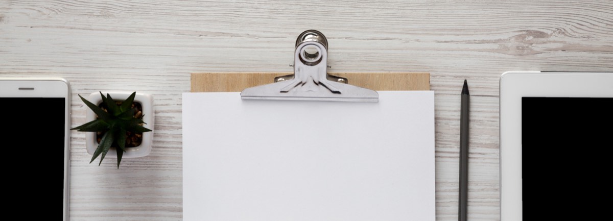 Founder reviewing a launch checklist on a clipboard at a startup desk