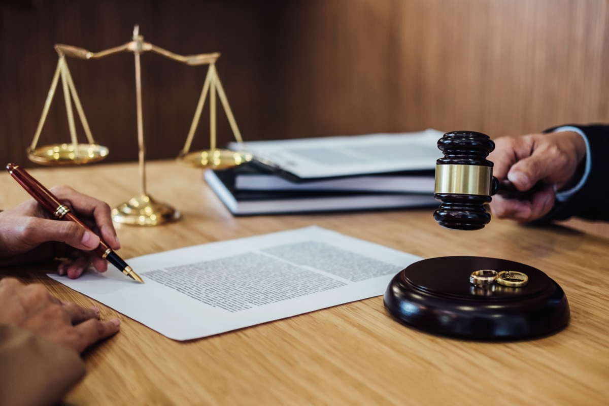 A wooden gavel resting on a stack of financial documents