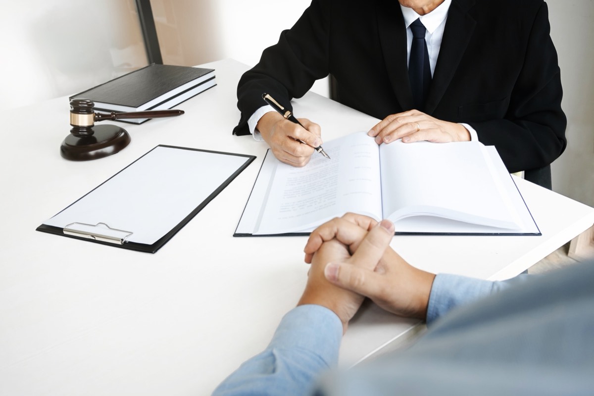 A professional reviewing trademark paperwork with a client across a desk