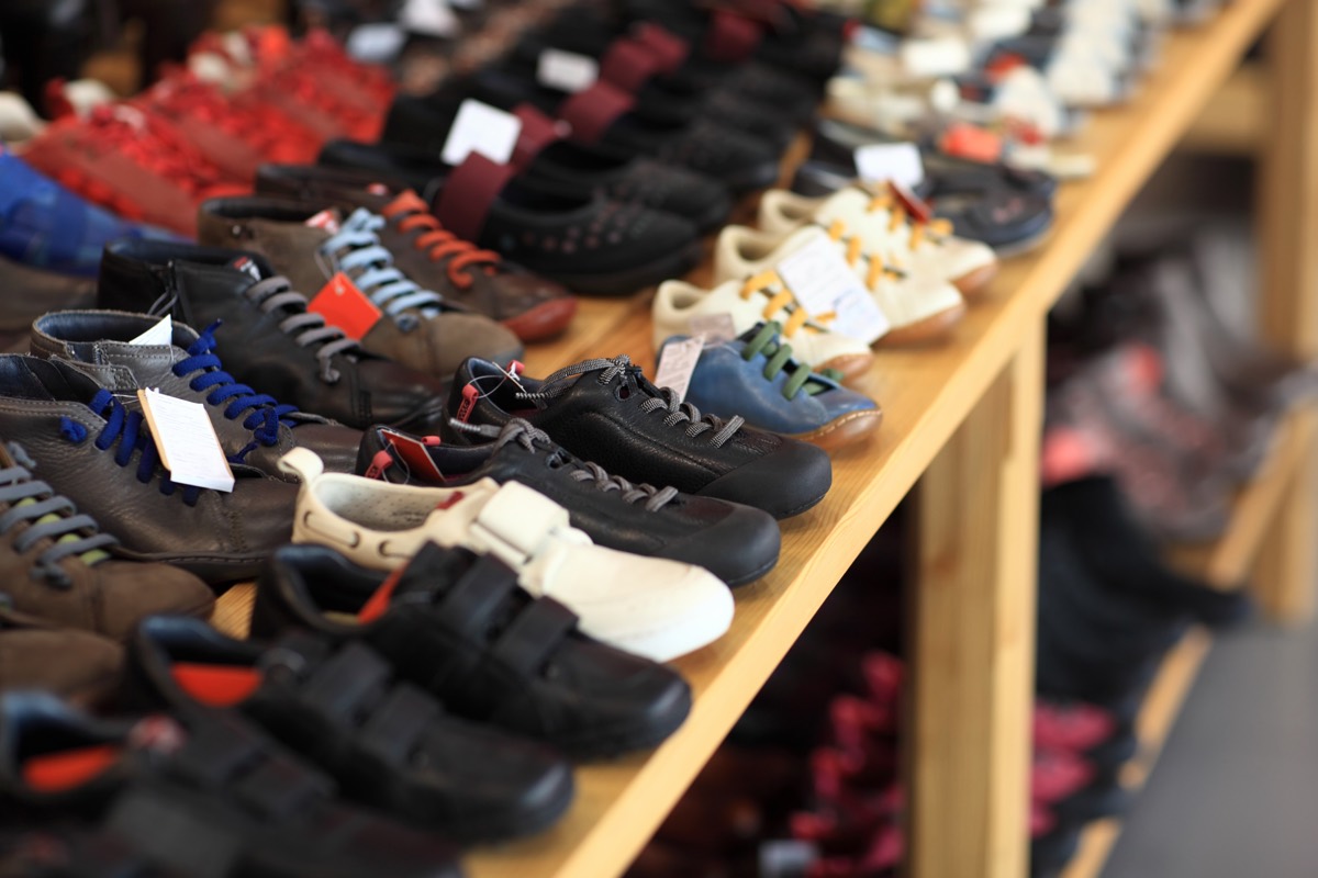 Row of colorful athletic sneakers displayed on a retail store shelf