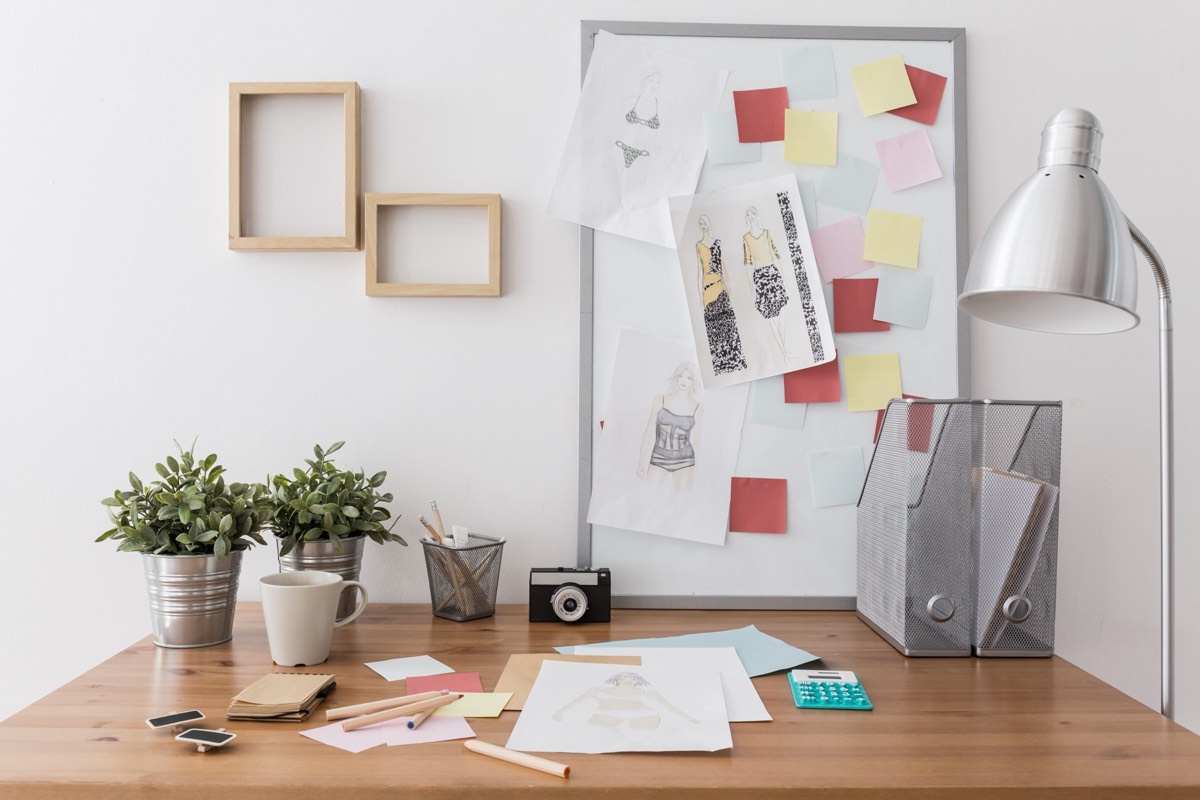 Creative workspace with headphones, fonts, and photos being prepared for a product