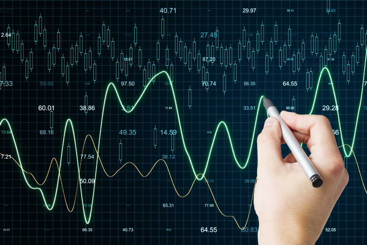 A financial analyst evaluating charts and a patent certificate
