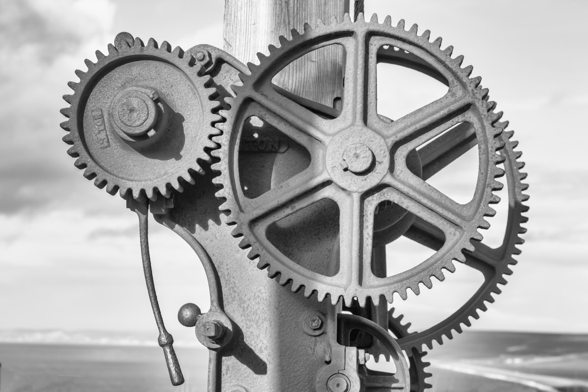 Inventor's workbench with prototype gears, sketches, and a lightbulb concept