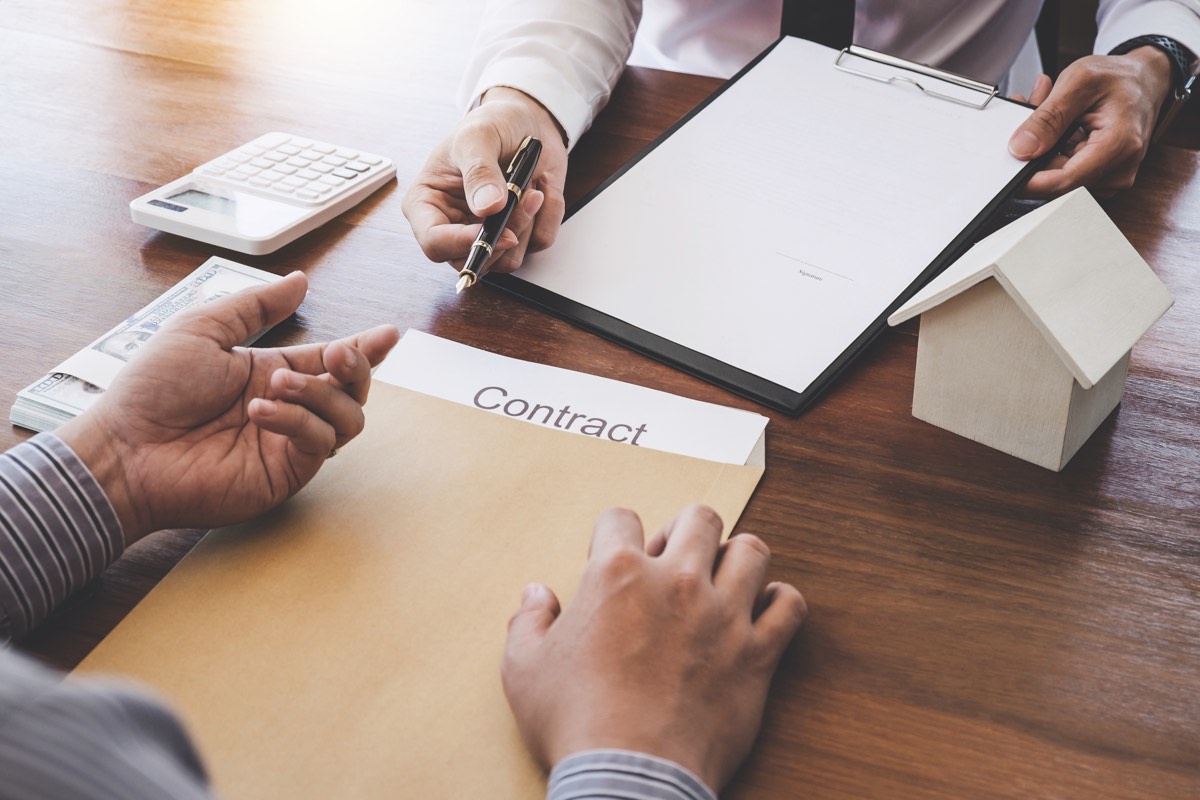 Startup founders and team members signing IP ownership and assignment documents at a table