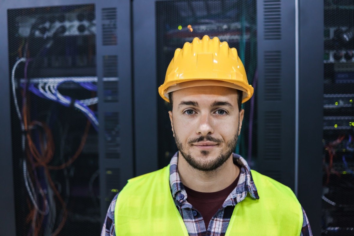 Rows of illuminated data server racks in a cloud storage facility