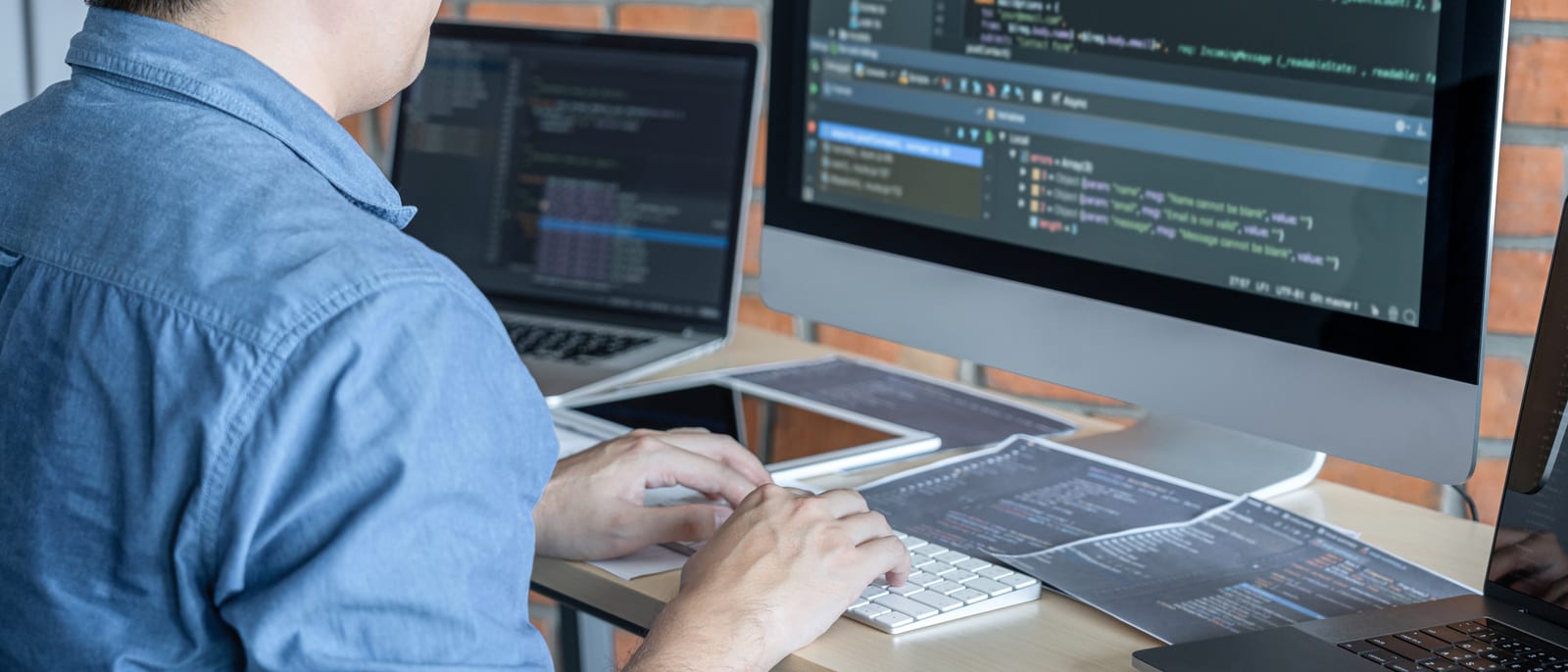 Lines of source code on a monitor in a dimly lit developer workspace