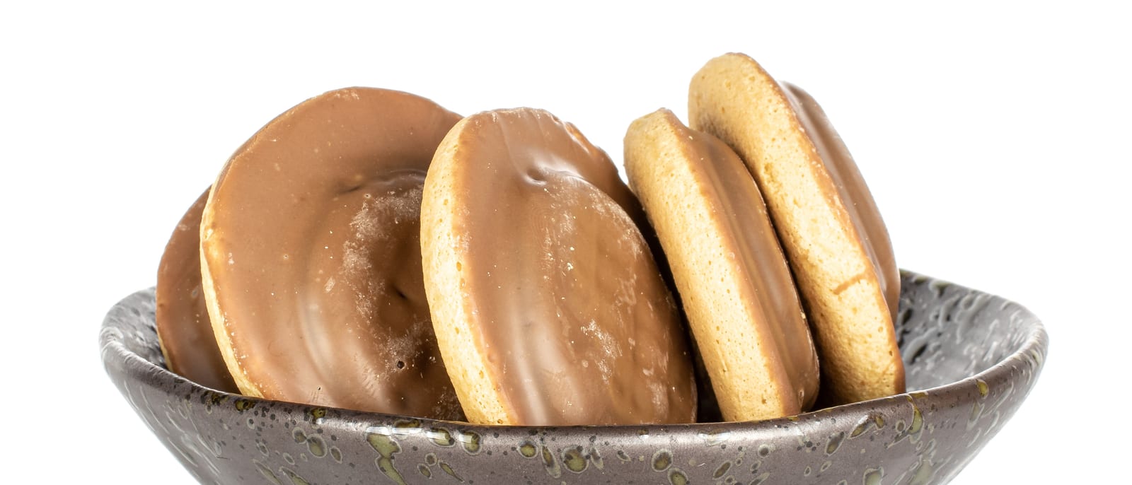 Pillow-shaped wheat cereal biscuits resting in a breakfast bowl with milk