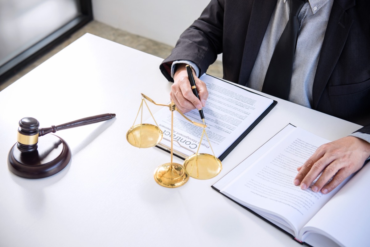 A patent attorney reviewing a stack of prosecution documents at a desk