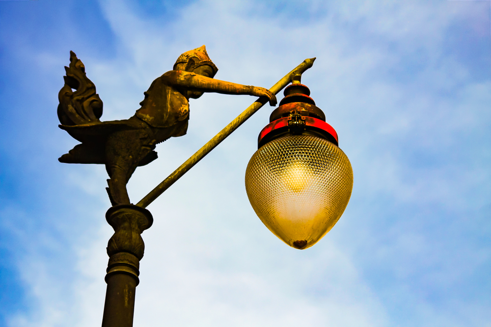 A decorative figurine sculpture serving as the base of an electric table lamp