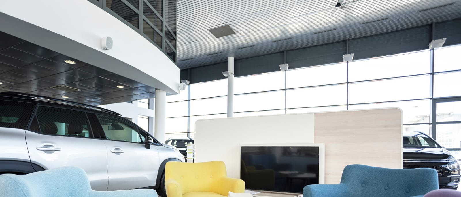 A polished luxury sedan displayed under bright showroom lights