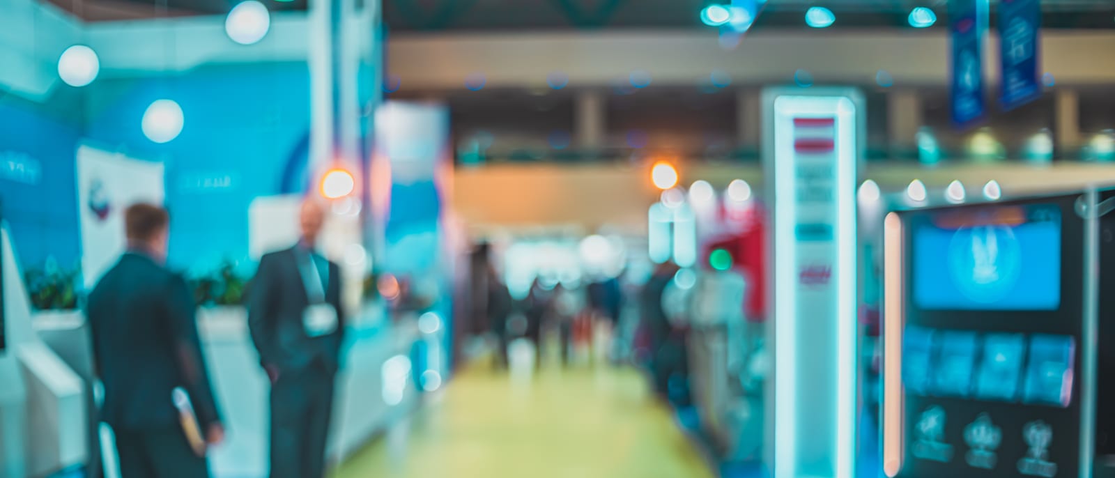 A trade show exhibition hall with booths and product displays under bright lighting