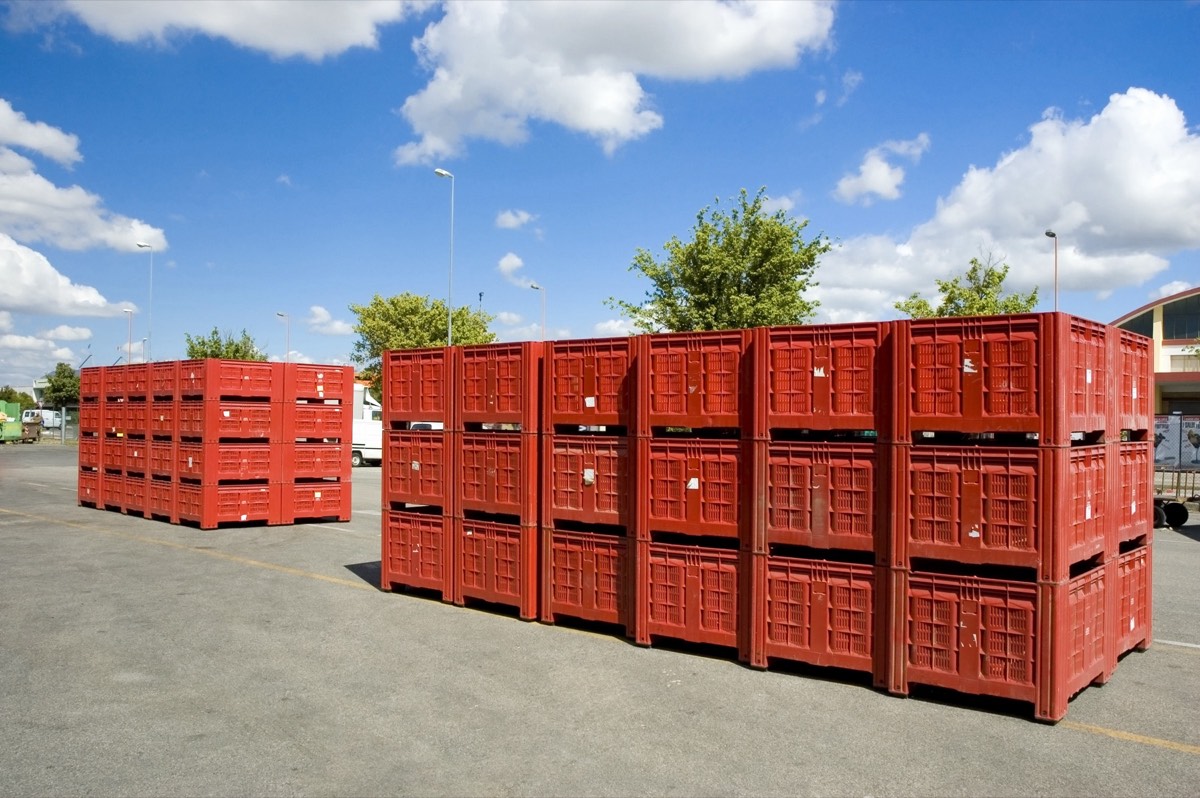 Disassembled industrial machine parts in shipping crates