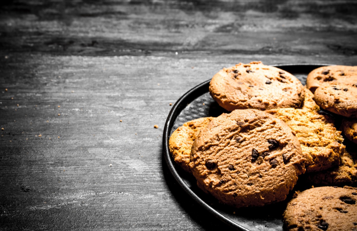 A tray of freshly baked chocolate chip cookies cooling in a commercial bakery