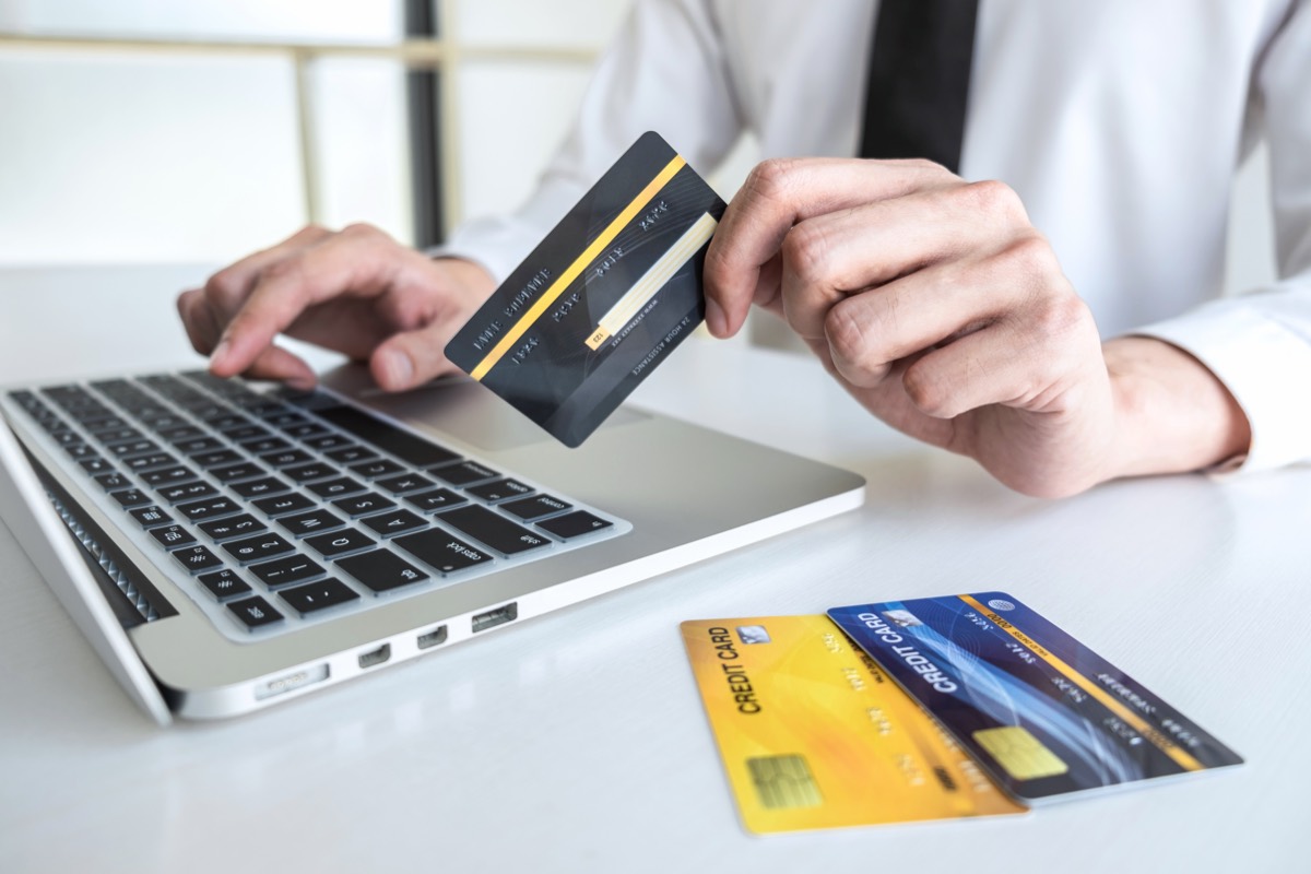 Close-up of a person entering credit card details on a laptop for an online payment