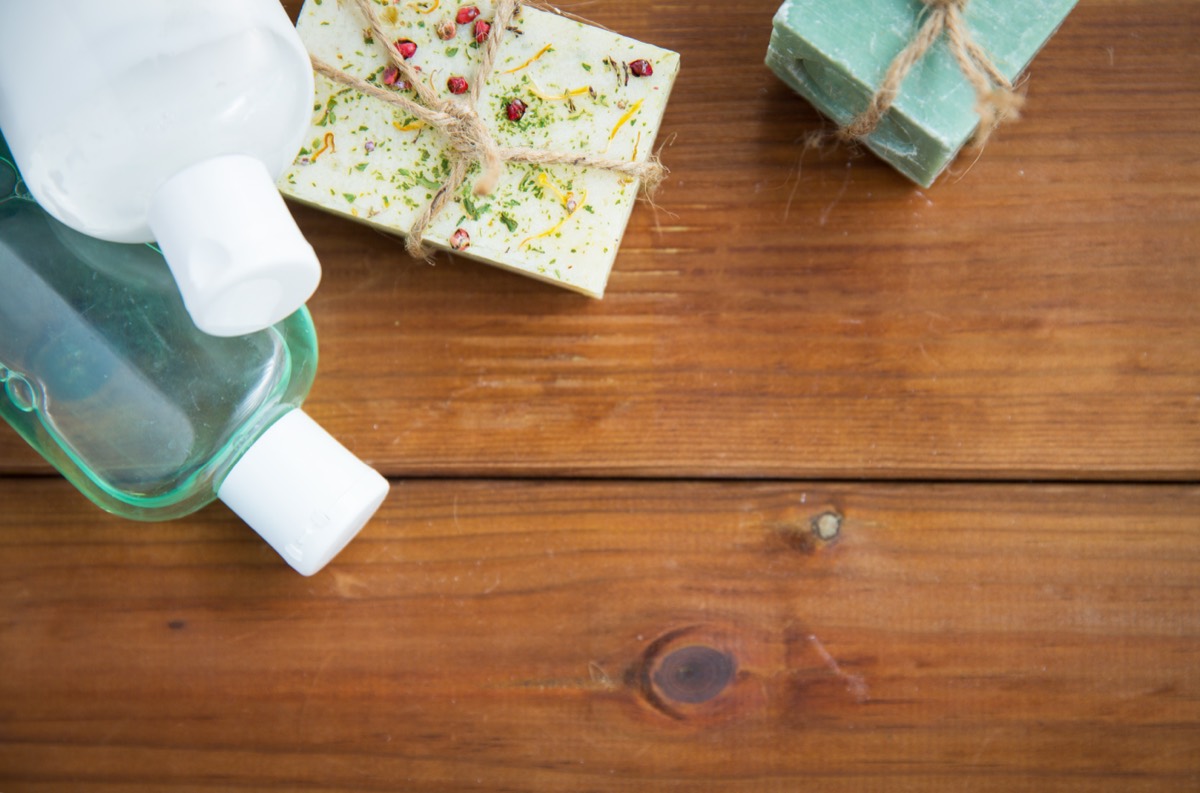 Stacks of colorful handmade soap bars arranged on a wooden table in a cosmetics shop