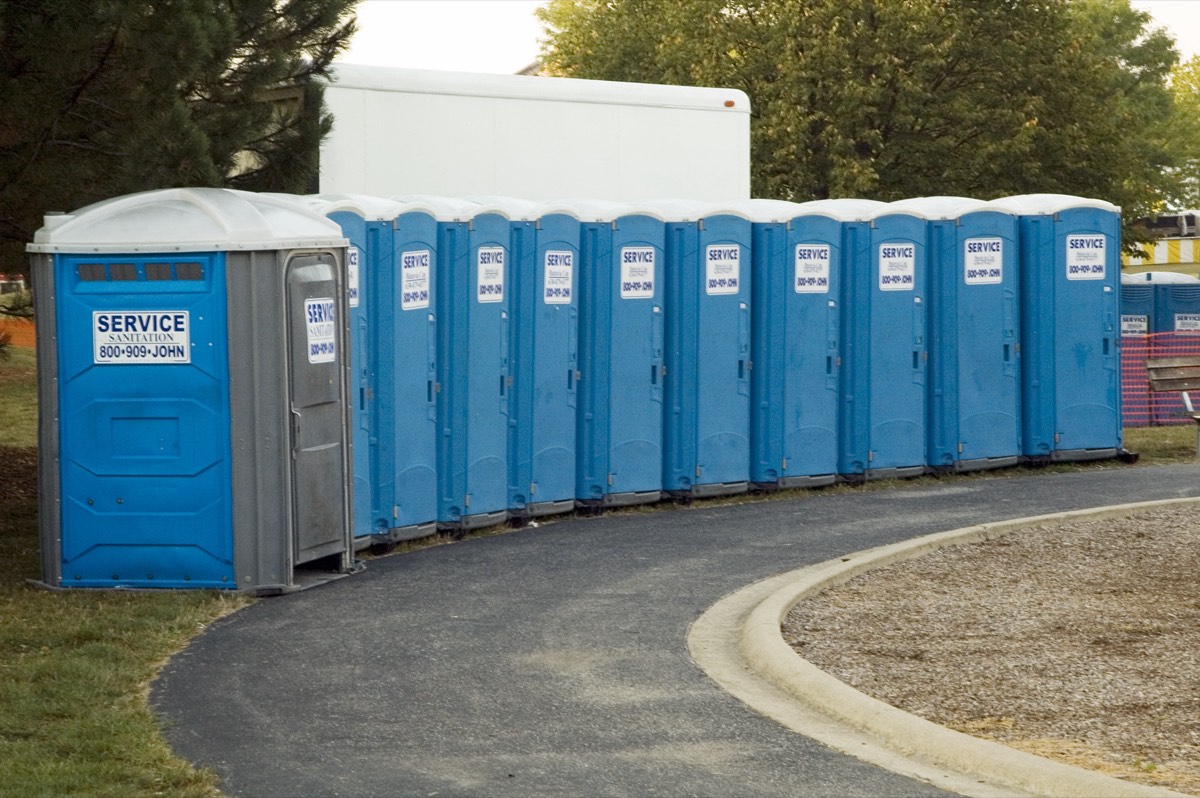 A row of portable toilets at an outdoor event