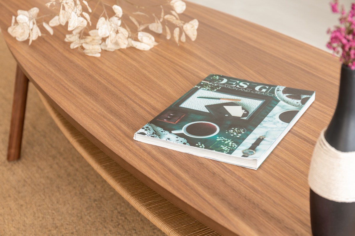 Open glossy fashion magazine spread lying on a table