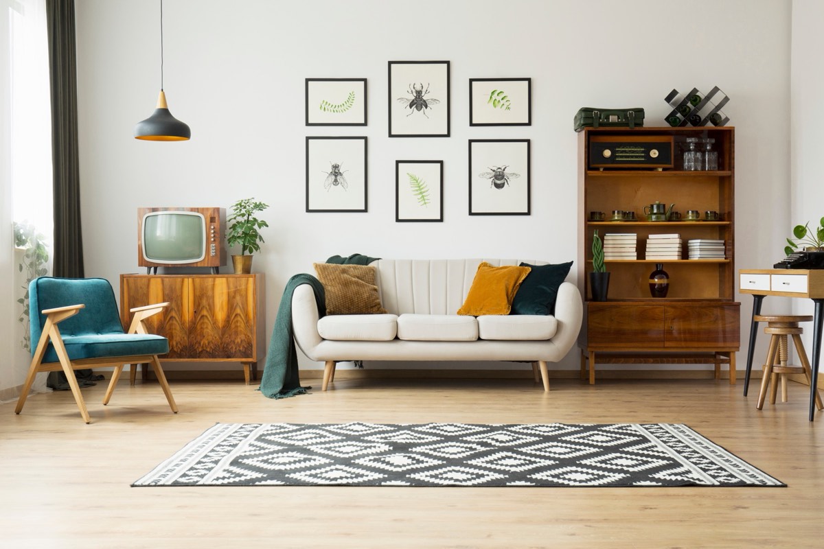 A vintage television set glowing in a dark mid-century living room