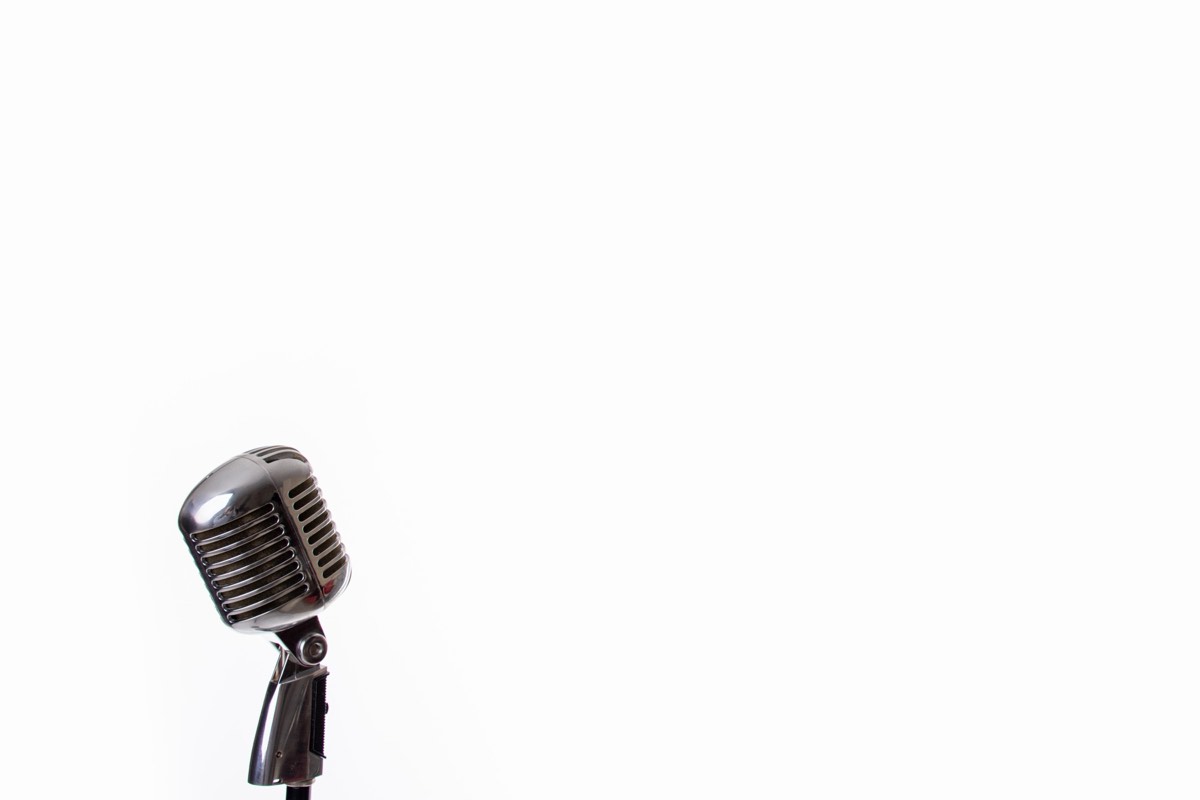 A vintage studio microphone in a recording booth