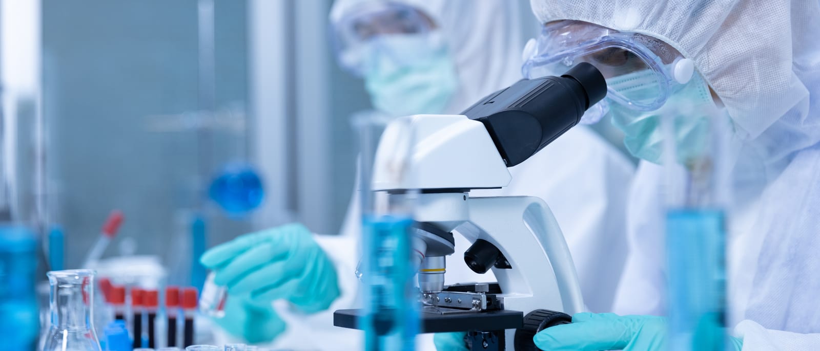 Scientist loading samples into a DNA sequencing machine in a genomics lab