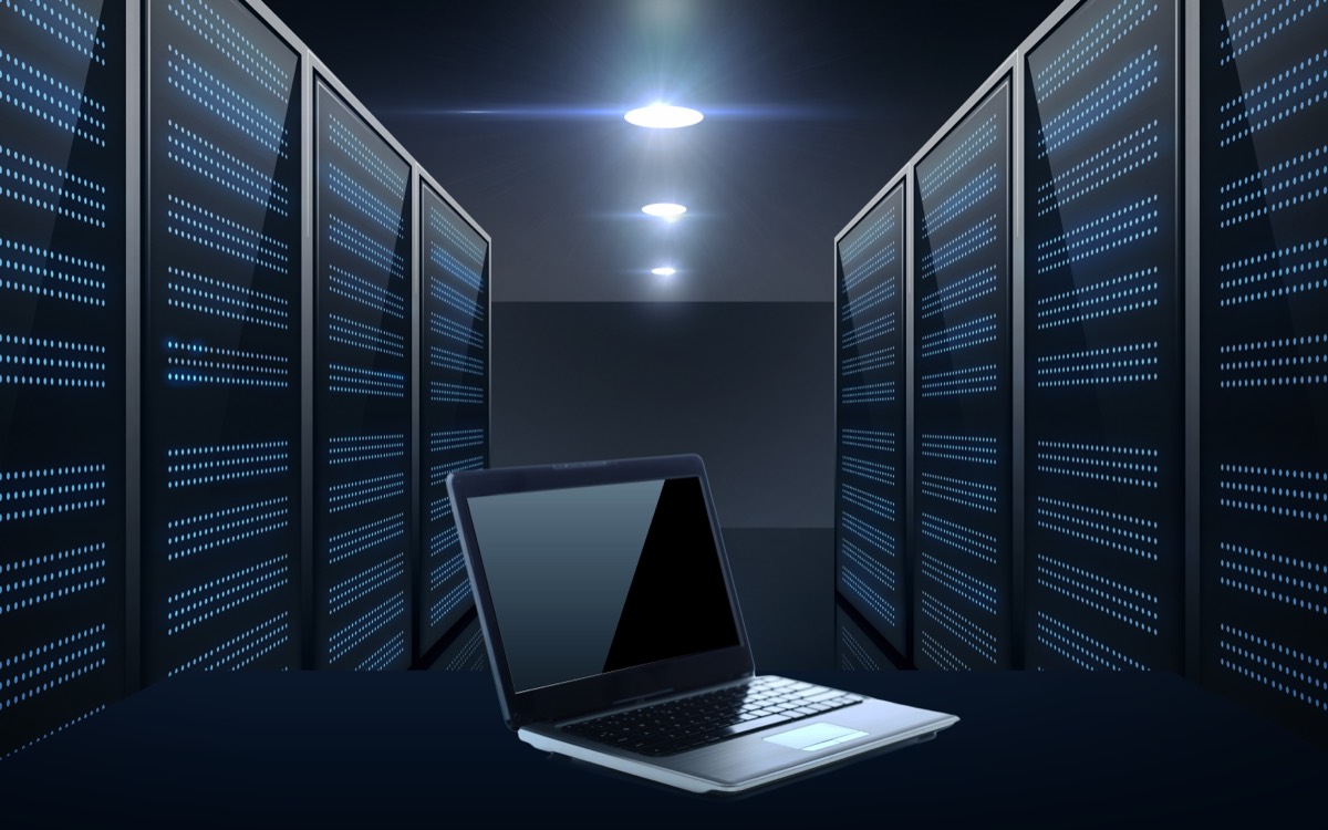 A newsroom desk with a laptop showing article bylines beside a server rack icon