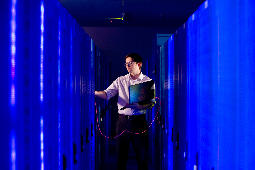 Rows of network servers with cabling in a data center