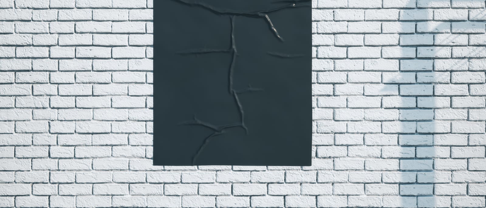 A weathered vintage advertising poster pasted on a brick storefront wall